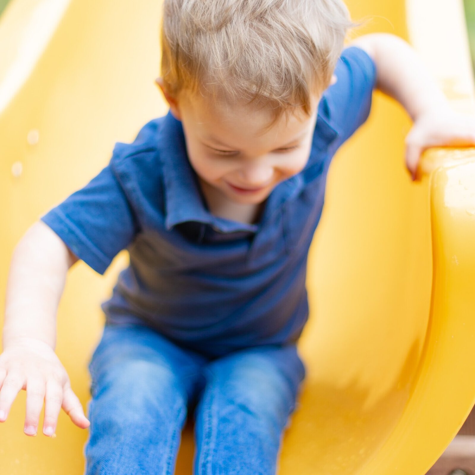 kid going down slide