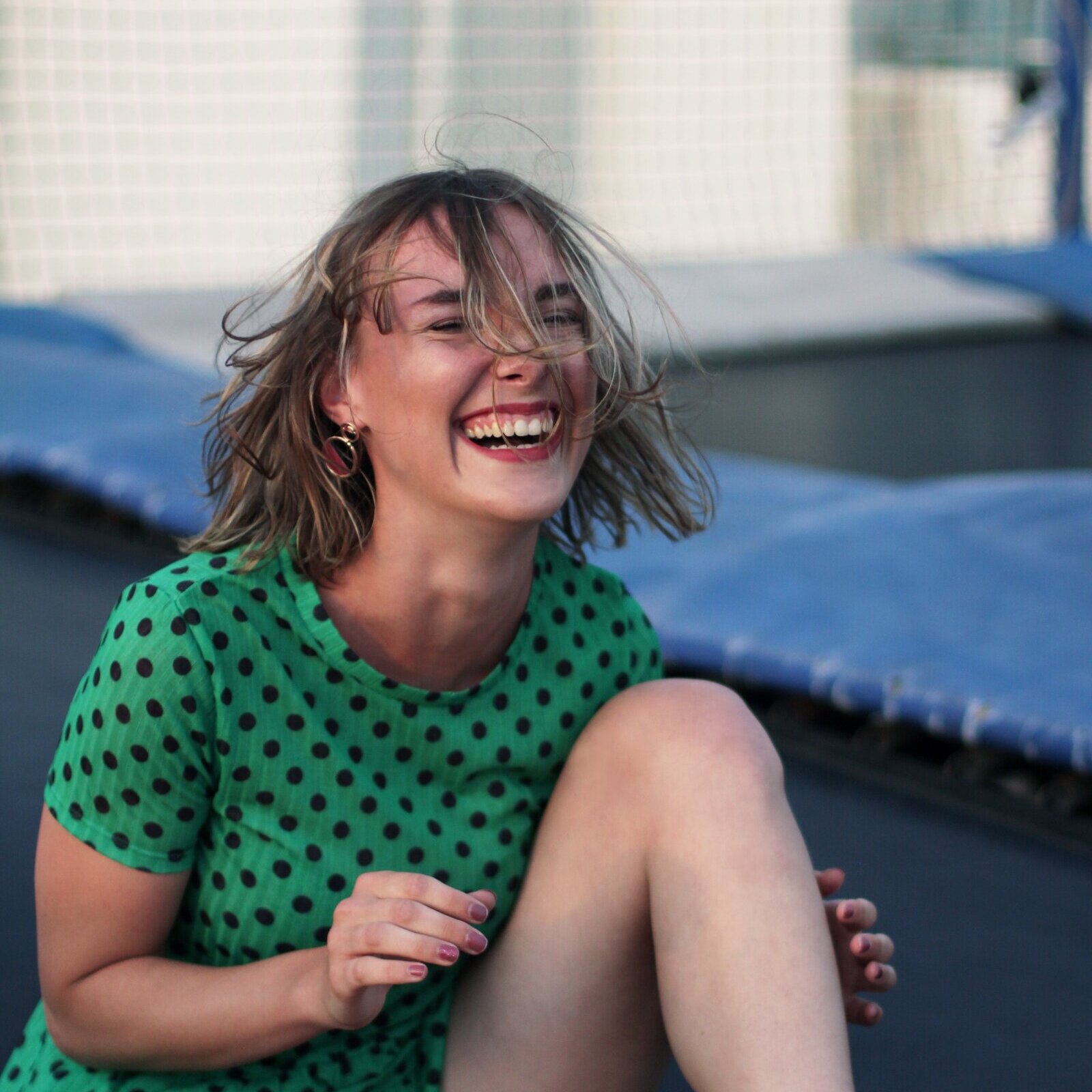 woman sitting on trampoline